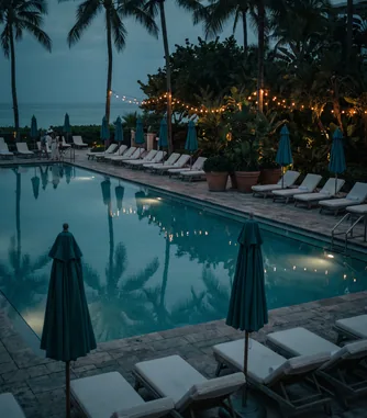 Resort pool with umbrellas in the evening